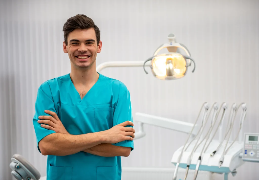 smiling man in scrubs standing confidently at dent 2026 04 10 22 59 16 utc 1